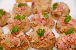 Potato Pancakes decorated with sour cabbage and pieces of fried bacon