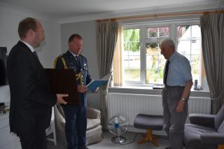 Handing over the decree and the Medal for Heroism to Col. Nečas-Pemberton, Rtd.  