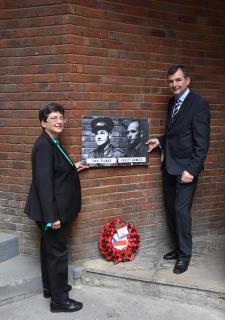 Mrs. Anita Moravec Gard and Col. Jiří Niedoba in front of the wall where Jan Kubiš and Jozef Gabčík were photographed