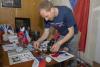 Making buttons at the Public Diplomacy table - Photo credit: Lillis Werder