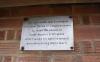 The commemorative plaque on the bus shelter