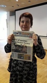 Judita Matyášová holding the newspapers where the advertisement has been published