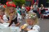 Young girls, dressed in the Czech national costume Kroj, participate in a kolache eating contest at the National Polka Festival in Ennis. By Melanie Zavodny