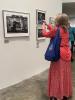 A guest captures a photo she sees at the opening.