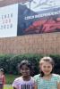 Children stand in front of Czech Independence banner.